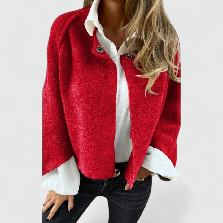A woman wearing a relaxed open-front jacket over a blouse