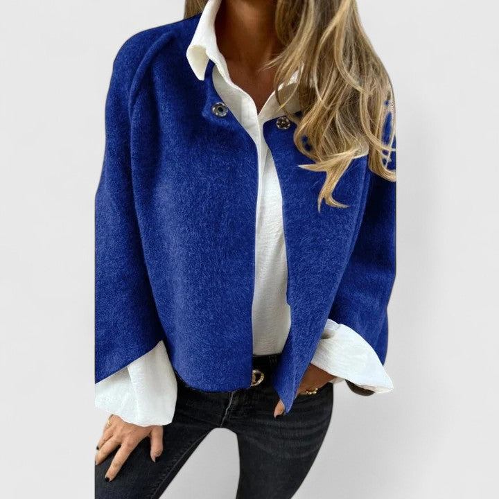 A woman wearing a relaxed open-front jacket over a blouse
