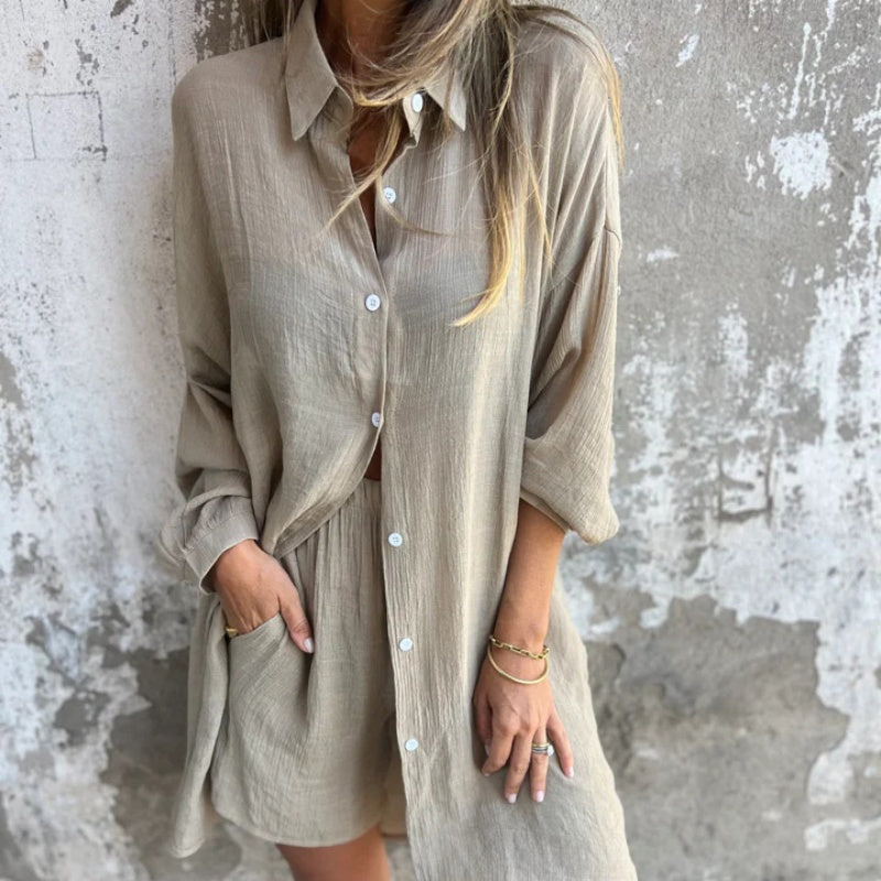 A woman wearing a relaxed beige button-front shirt with matching shorts
