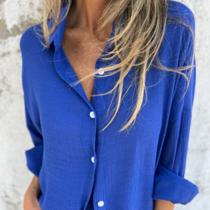A woman wearing a relaxed beige button-front shirt with matching shorts