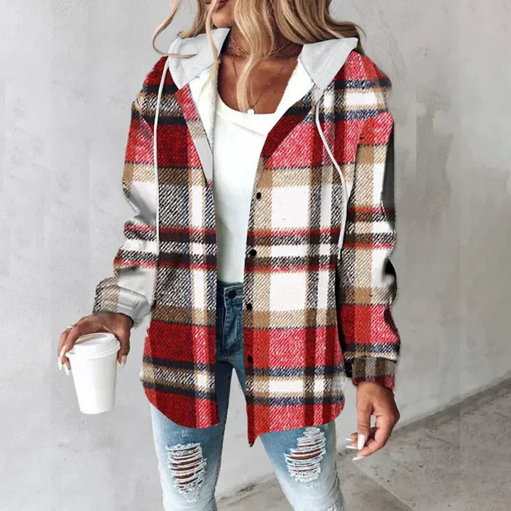 A woman wearing a grey and white checked hooded jacket with a button front